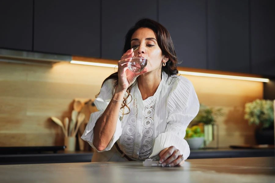 Menopausal woman taking a supplement